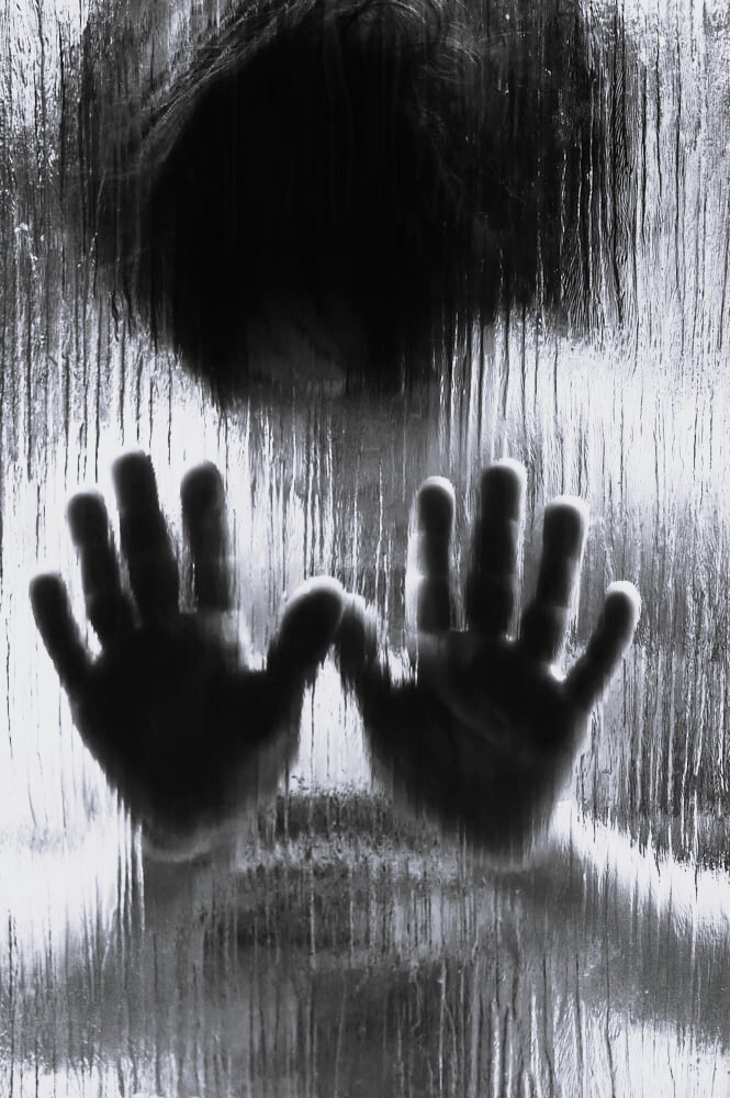 Silhouette of abused child behind the glass-1